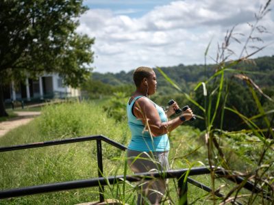 Woman jogging through a park to support physical and mental health during perimenopause.